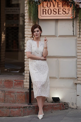 a lady in a white openwork dress and a white openwork jacket
